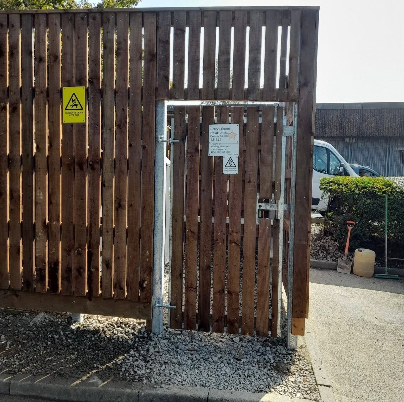 Timber-clad electricity substation enclosure with galvanised pedestrian access gate