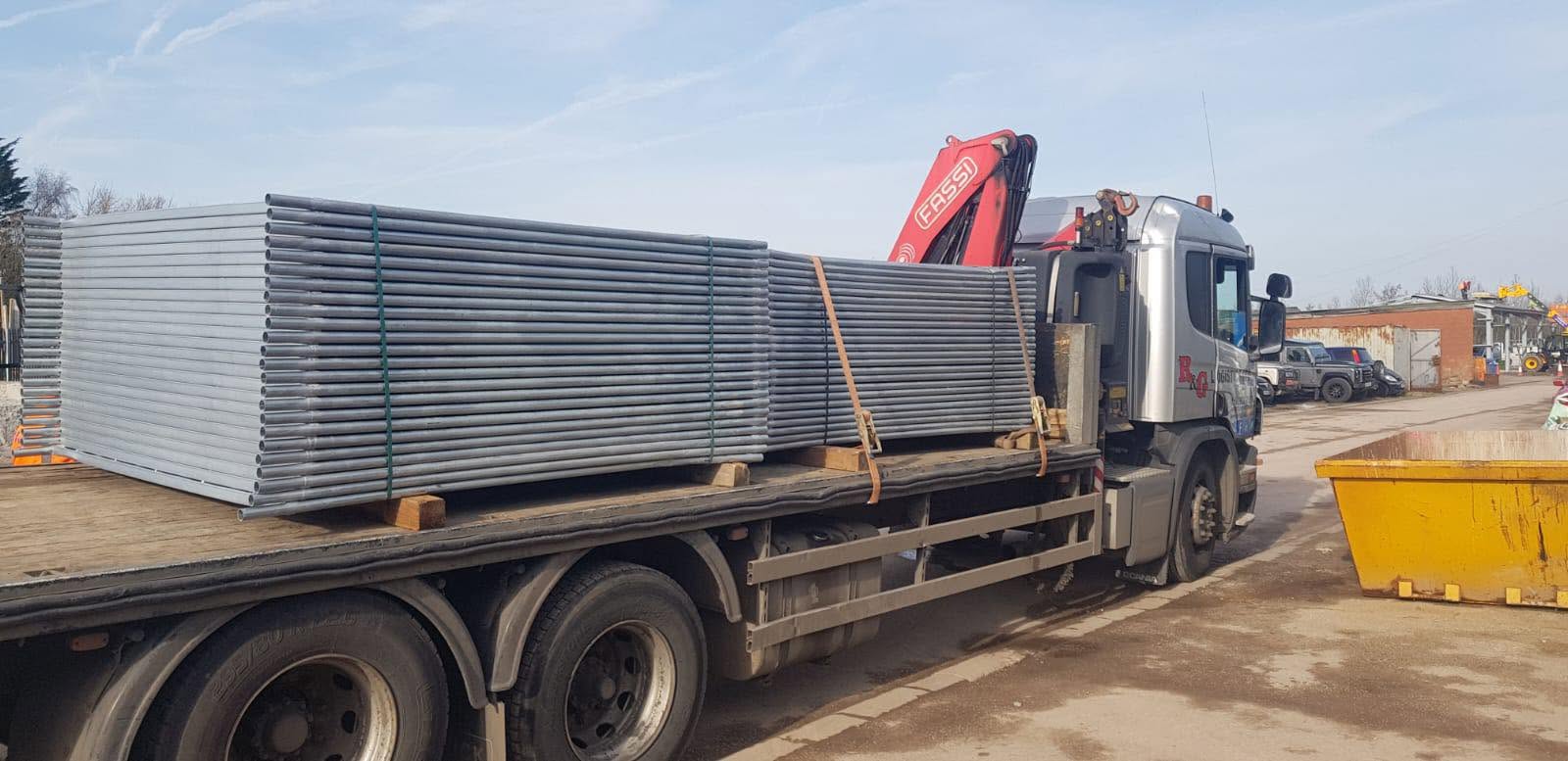 HIAB lorry loaded with galvanised palisade fencing ready for delivery to a North West site
